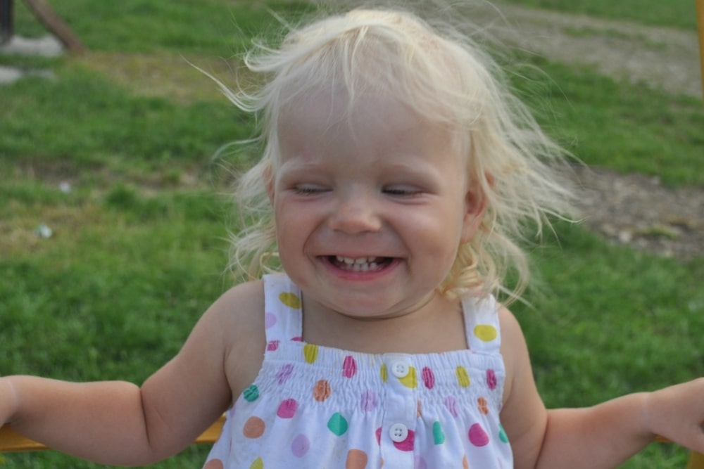 smiling laughing little blonde girl