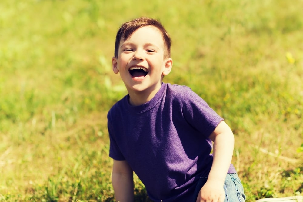 smiling laughing little boy outdoors