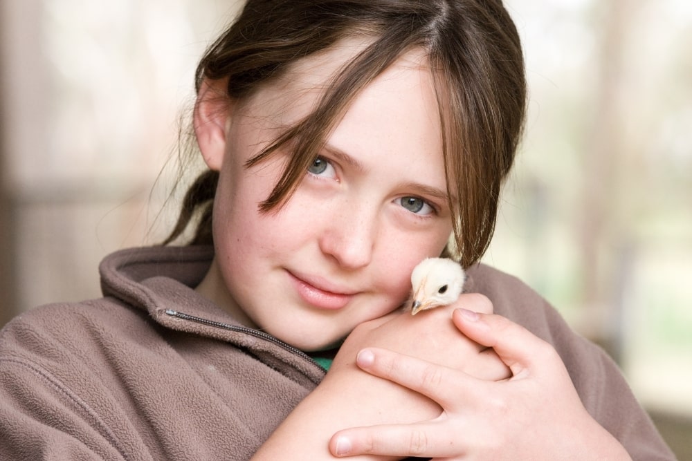 girl holding chick
