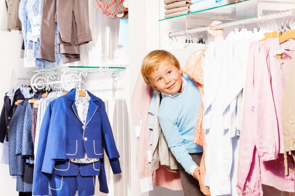 little boy looking at clothes